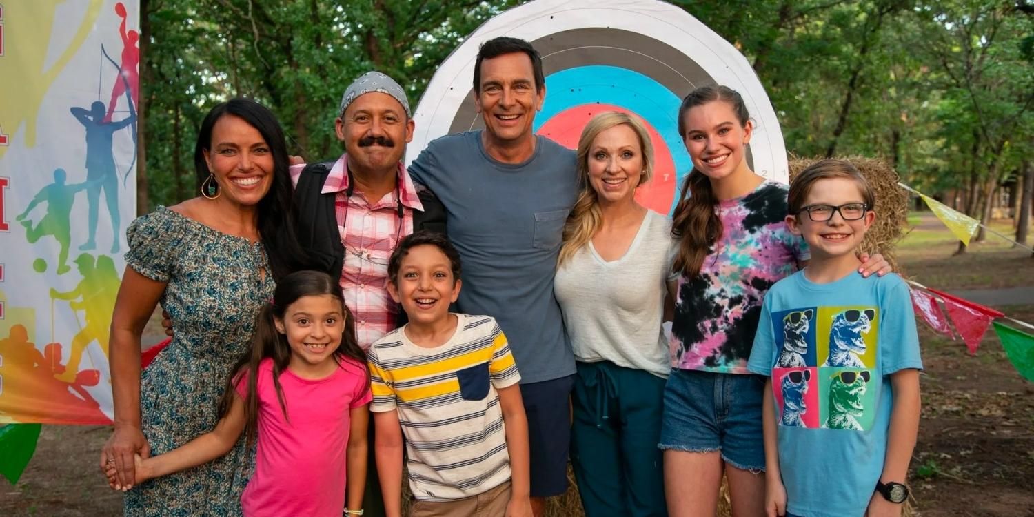 The cast of Family Camp together in front of an archery target.