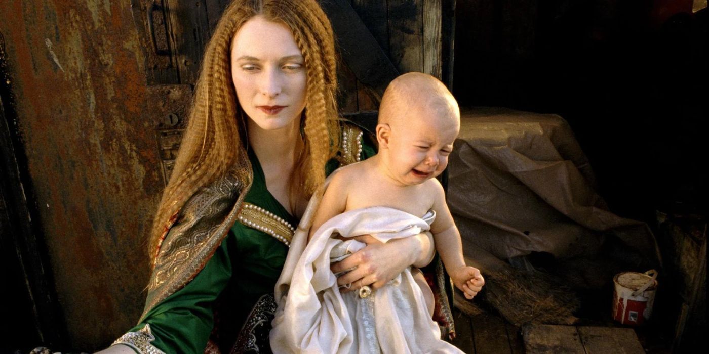 Madonna holding a baby in The Garden.
