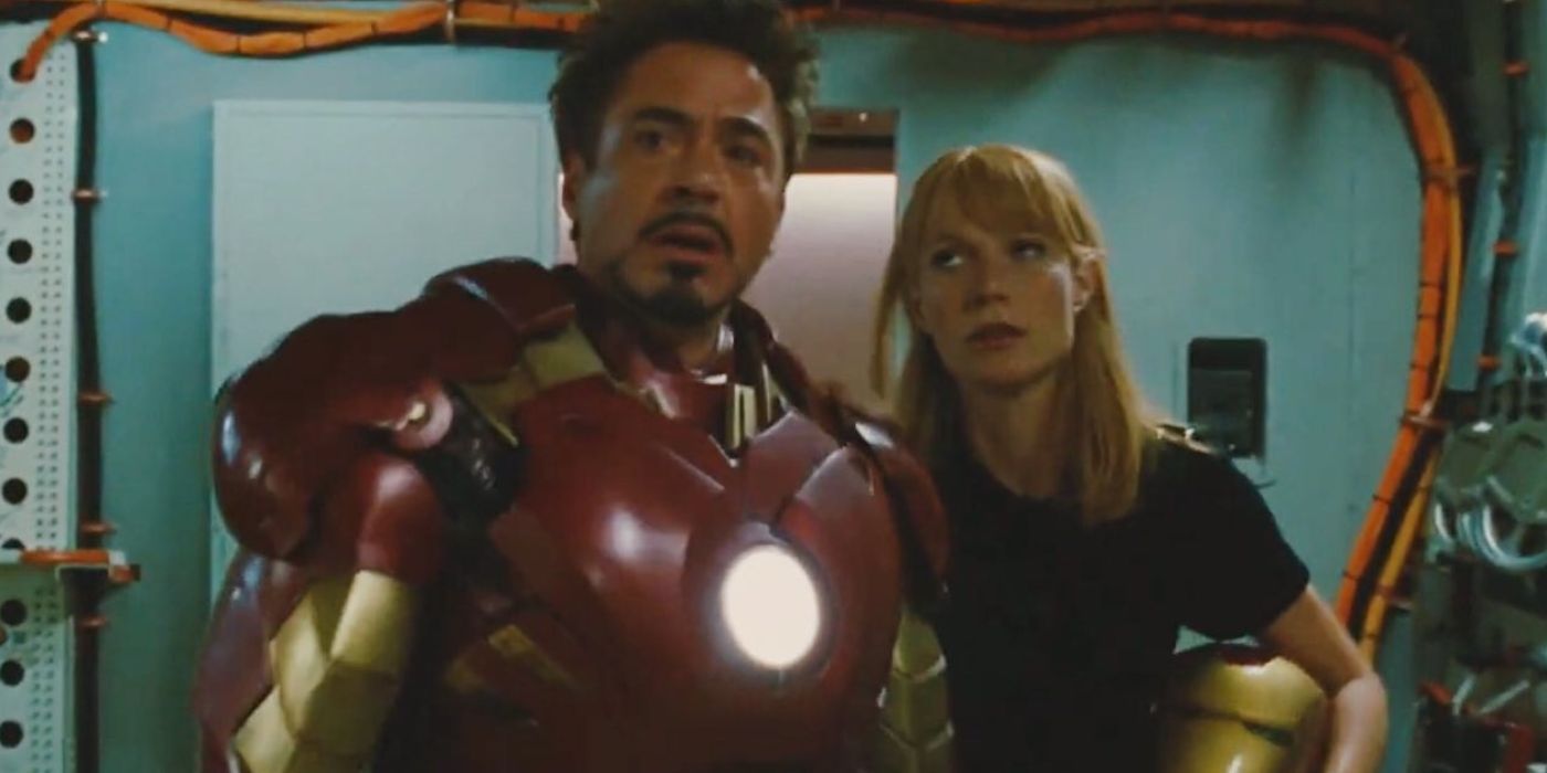 Tony Stark looking tearfully while Pepper Potts looks at him and holds the Iron Man mask in Iron Man 2 deleted scene