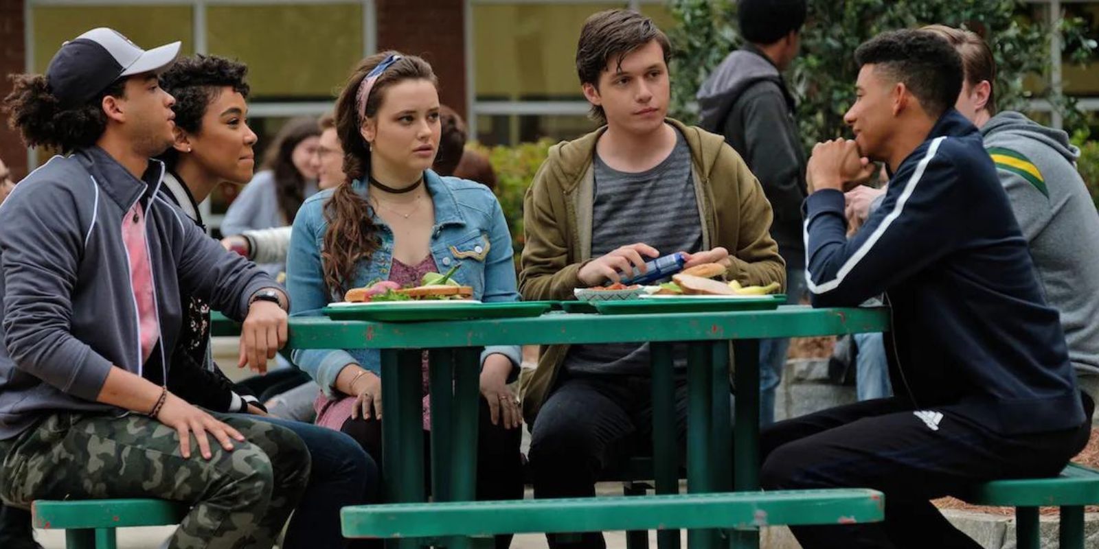 Simon and his friends sit at a lunch table