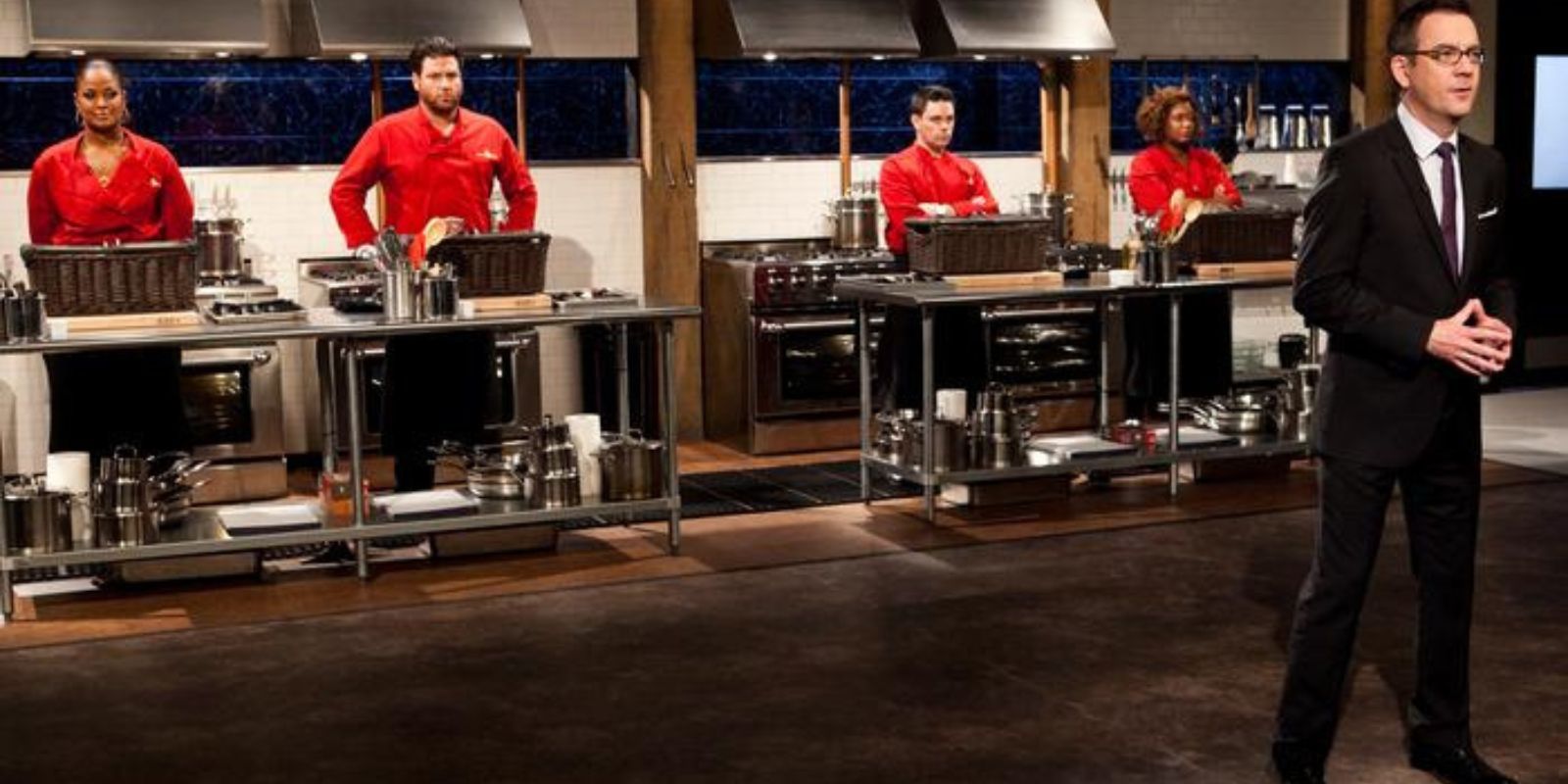 Chefs line up to cook with host in the front