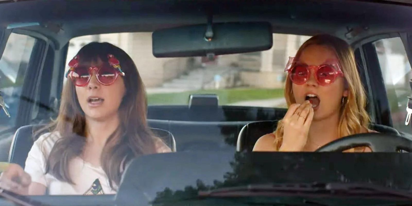 April and Clara sitting in a car with sunglasses on