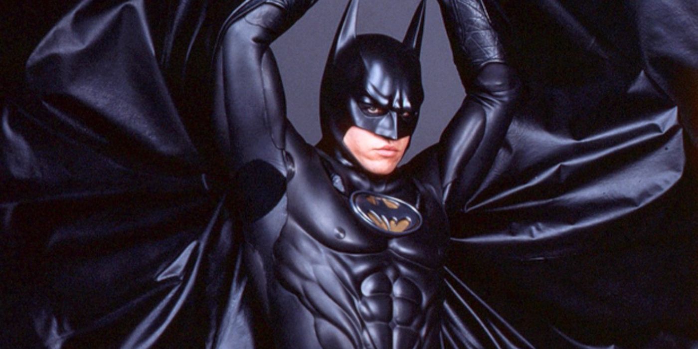 Val Kilmer raises hands above head in Batman Forever batsuit