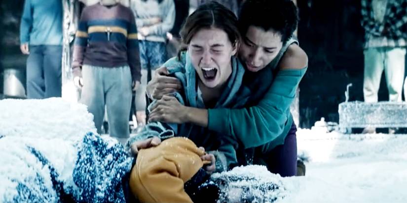 Shauna crying over Jackie's body while Taissa holds her in Yellowjackets