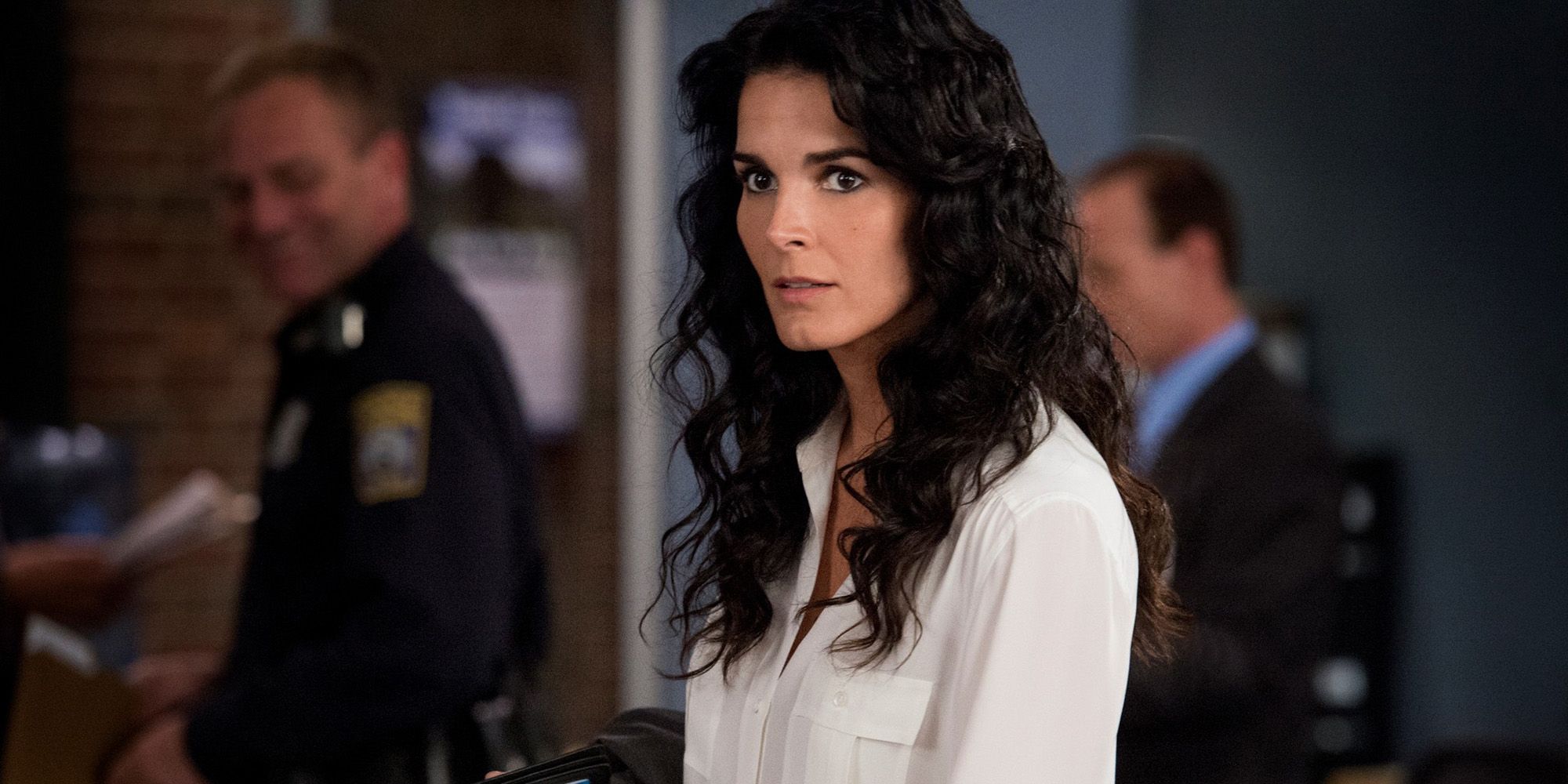 Angie Harmon looks on in Rizzoli and Isles