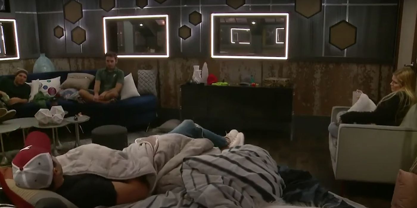 An image from the live feeds of Big Brother showing houseguests lying in bed, talking.