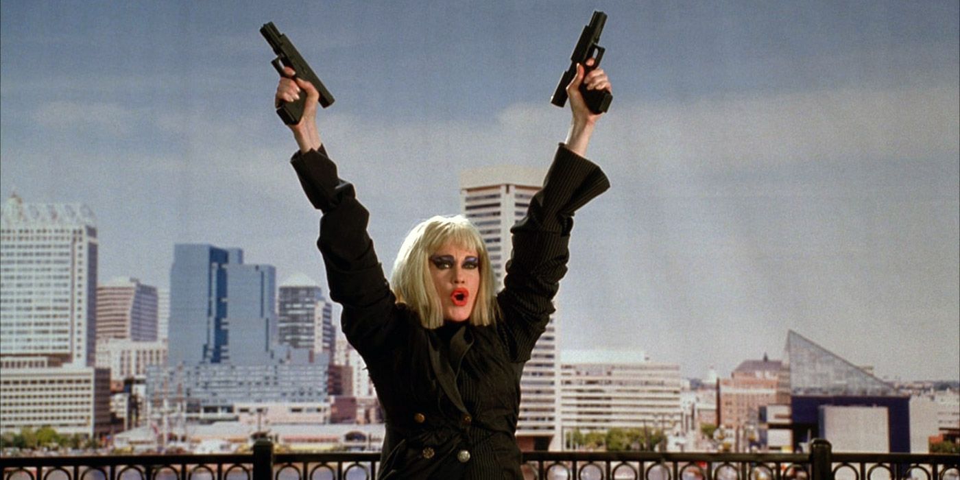 Honey Whitlock (Melanie Griffith) raising her arms and shooting off guns in Cecil B Demented.