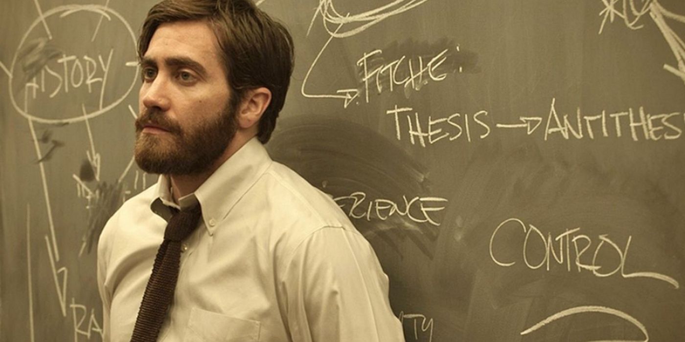 Jake Gyllenhaal leaning on a blackboard in Enemy