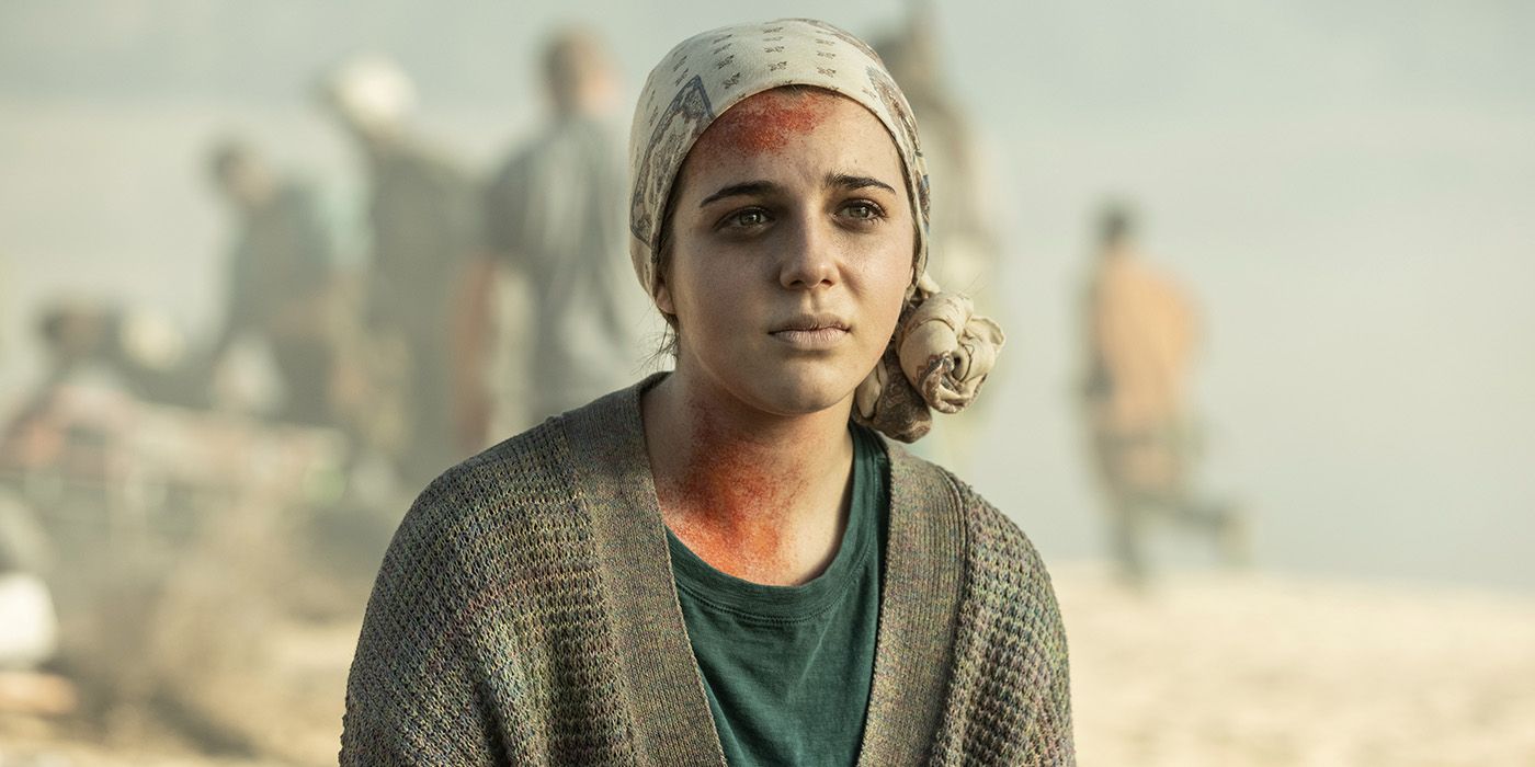 Charlie with a headband over her head, visibly sick sitting on the raft on Fear the Walking Dead.