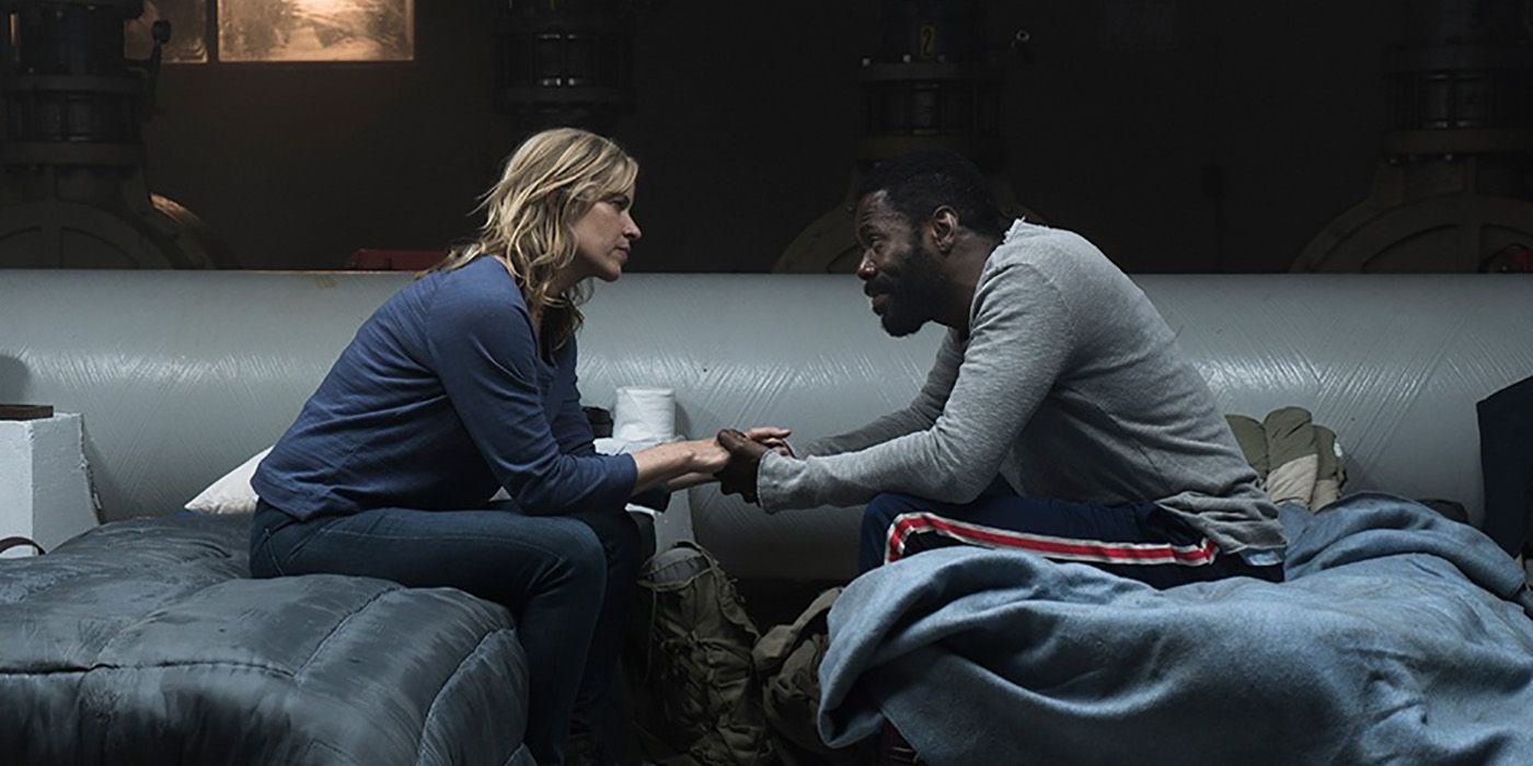 Victor and Madison sitting on beds, facing one another holding hands on Fear the Walking Dead.