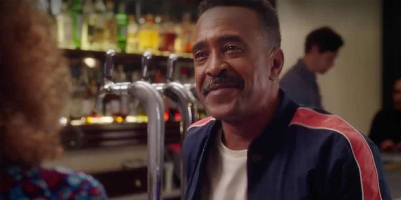 Tim Meadows sitting at the bar in a restaurant in a scene from Girls5eva.