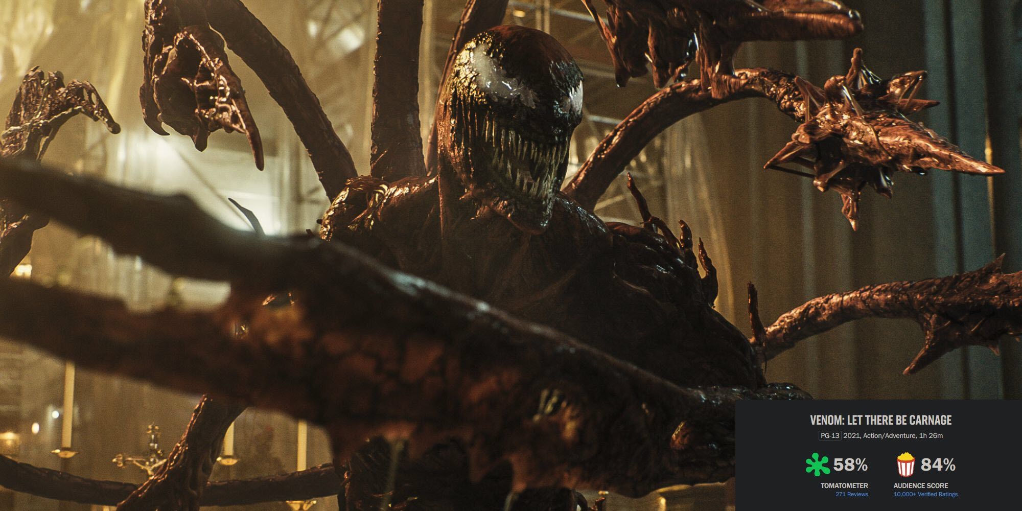 image from the 2021 film Venom Let There Be Carnage featuring the symbiote Carnage smiling menacingly with tendrils on his back