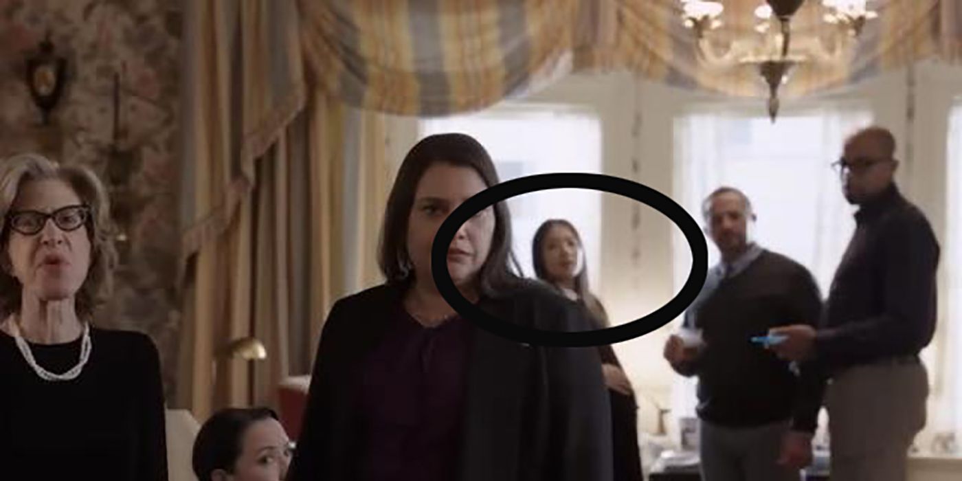 A circle highlighting Nina in the background of an image of guests from Bunny's memorial service on Only Murders in the Building.