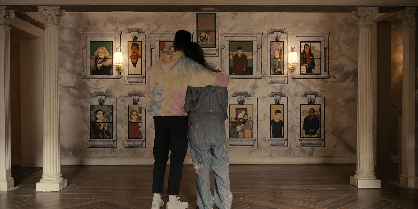 Oscar and Mabel's backs hugging, looking at her artwork of all the building's residents in Only Murders in the Building.