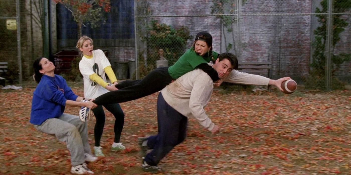 Rachel, Monica, Phoebe, and Joey playing football at the park in Friends