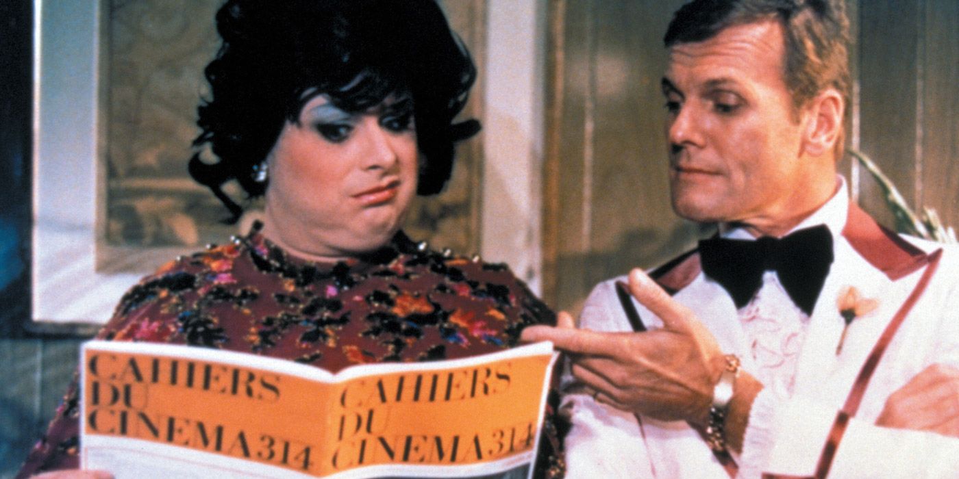Francine Fishpaw (Divine) sneering at a magazine next to a pleased looking Todd Tomorrow (Tab Hunter).