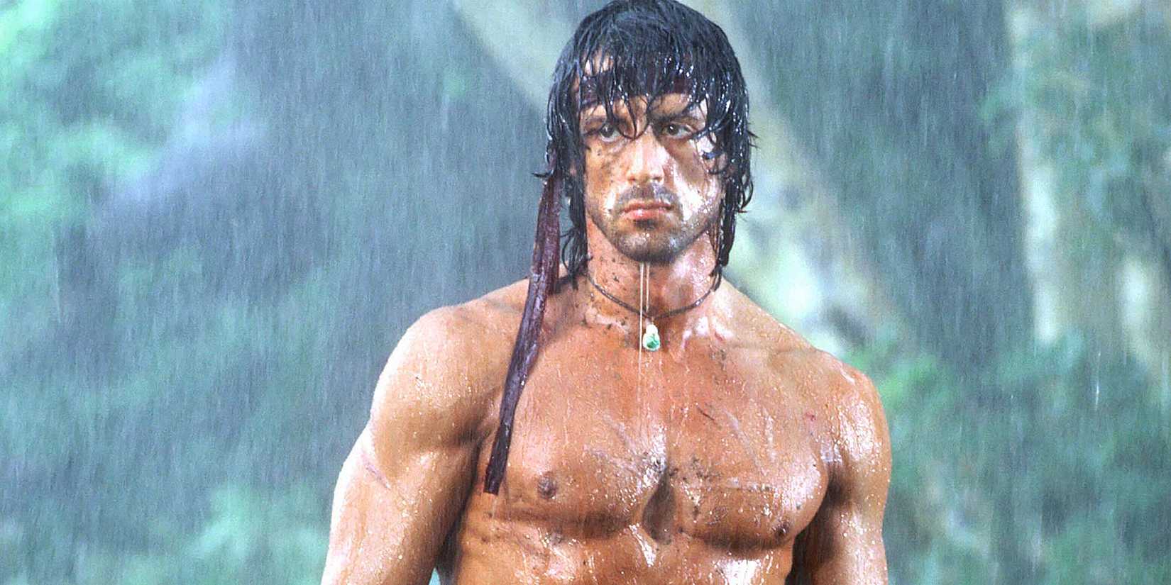 Sylvester Stallone as John Rambo standing in the rain in Rambo: First Blood Part II