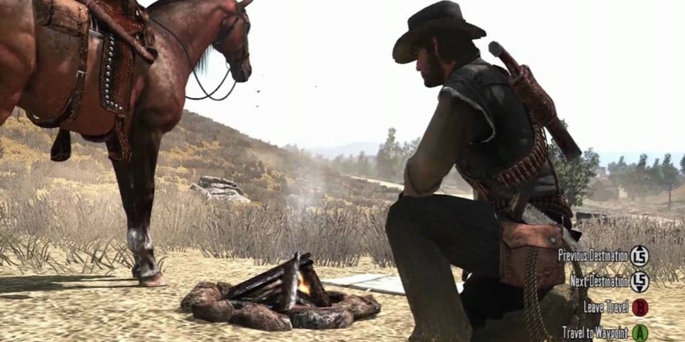 John kneels at a campsite in Red Dead Redemption