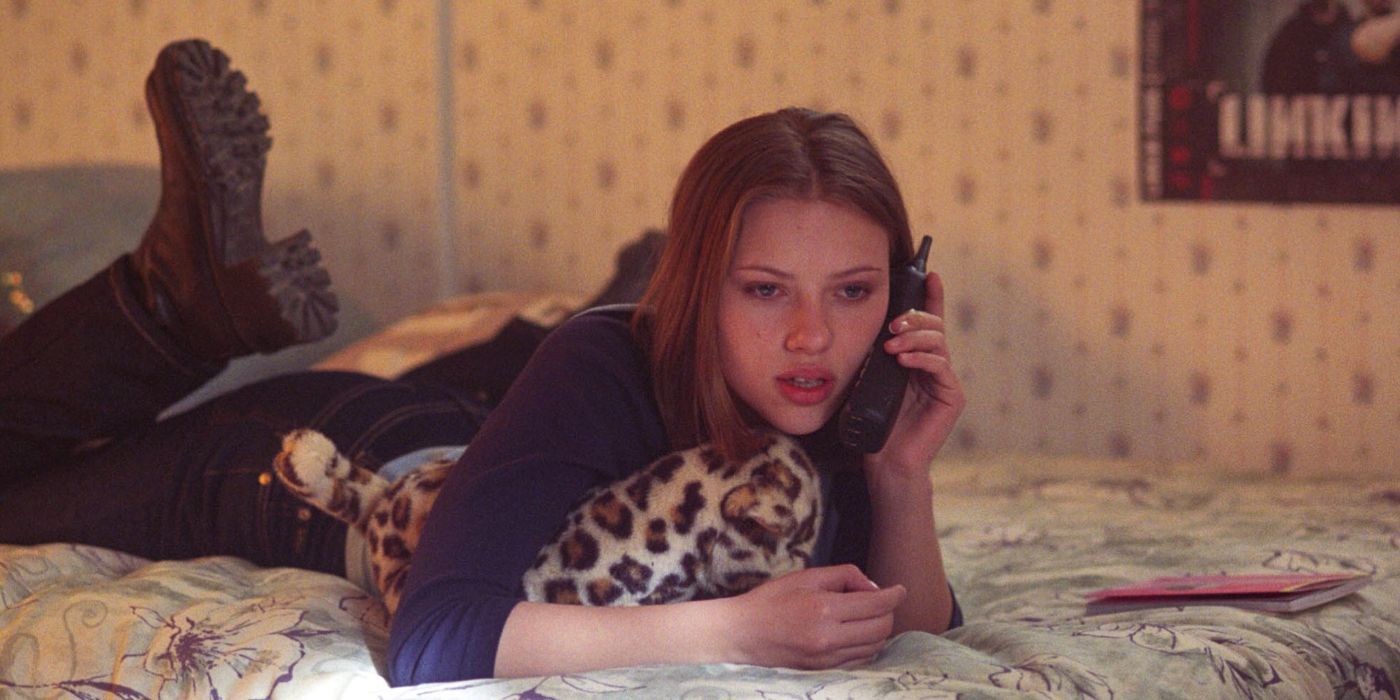 Scarlet Johansson using a phone while lying on a bed