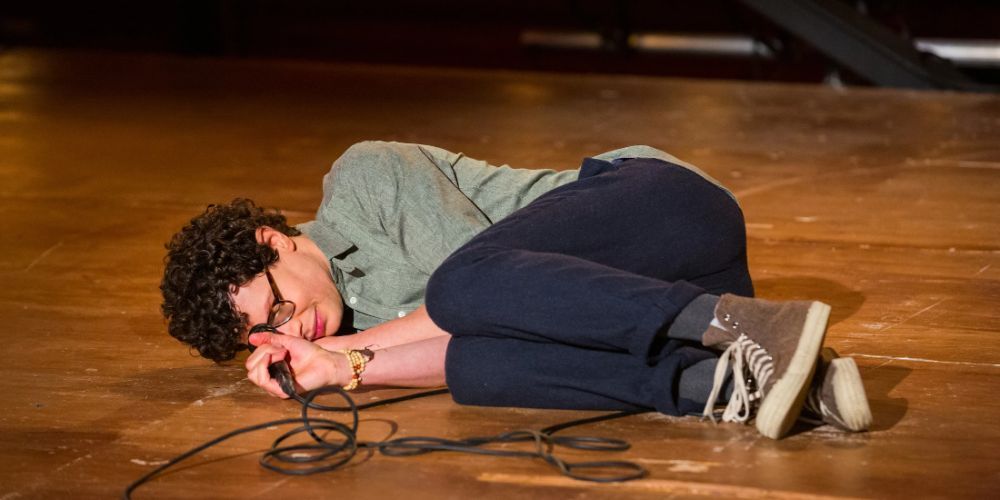 Simon Amstell lying on the floor during his comedy special Set Free