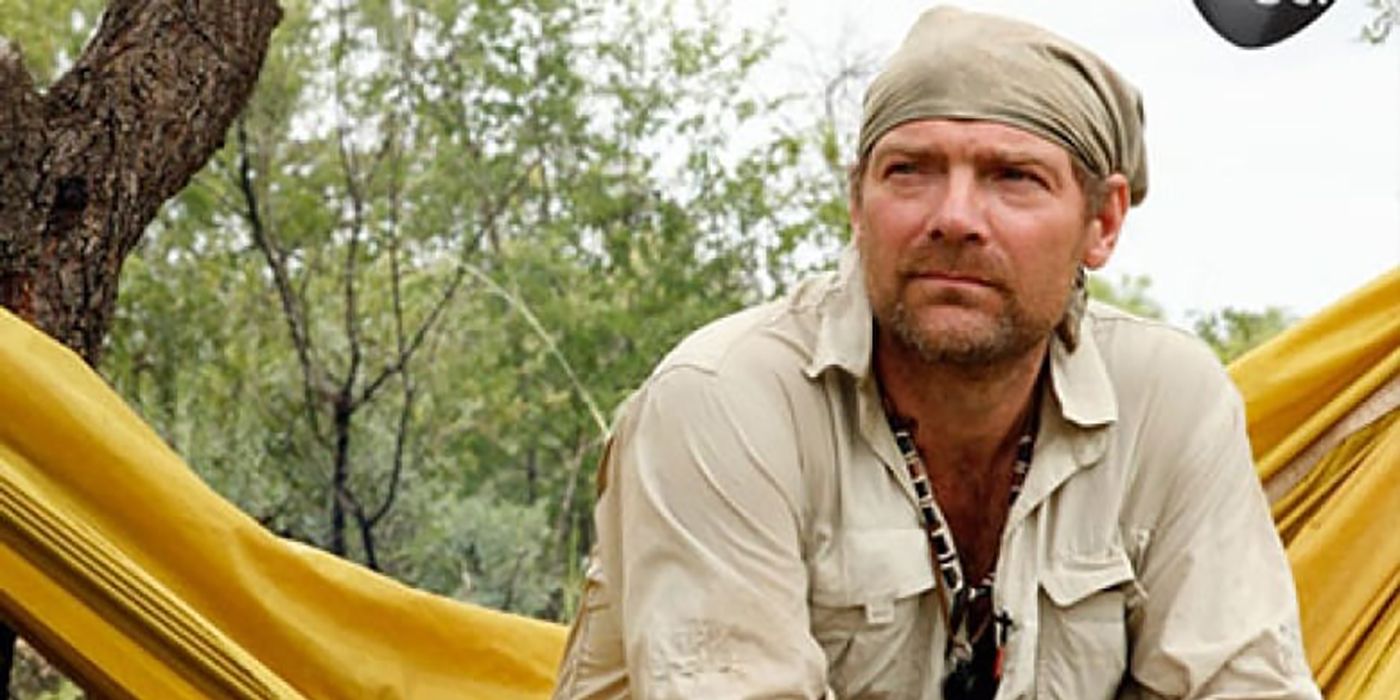 Les Stroud from Survivorman sitting on a hammock, looking up.