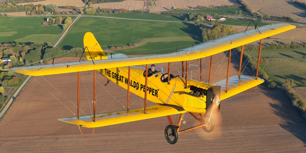 Waldo flies his yellow plane over a dirt field in The Great Waldo Pepper