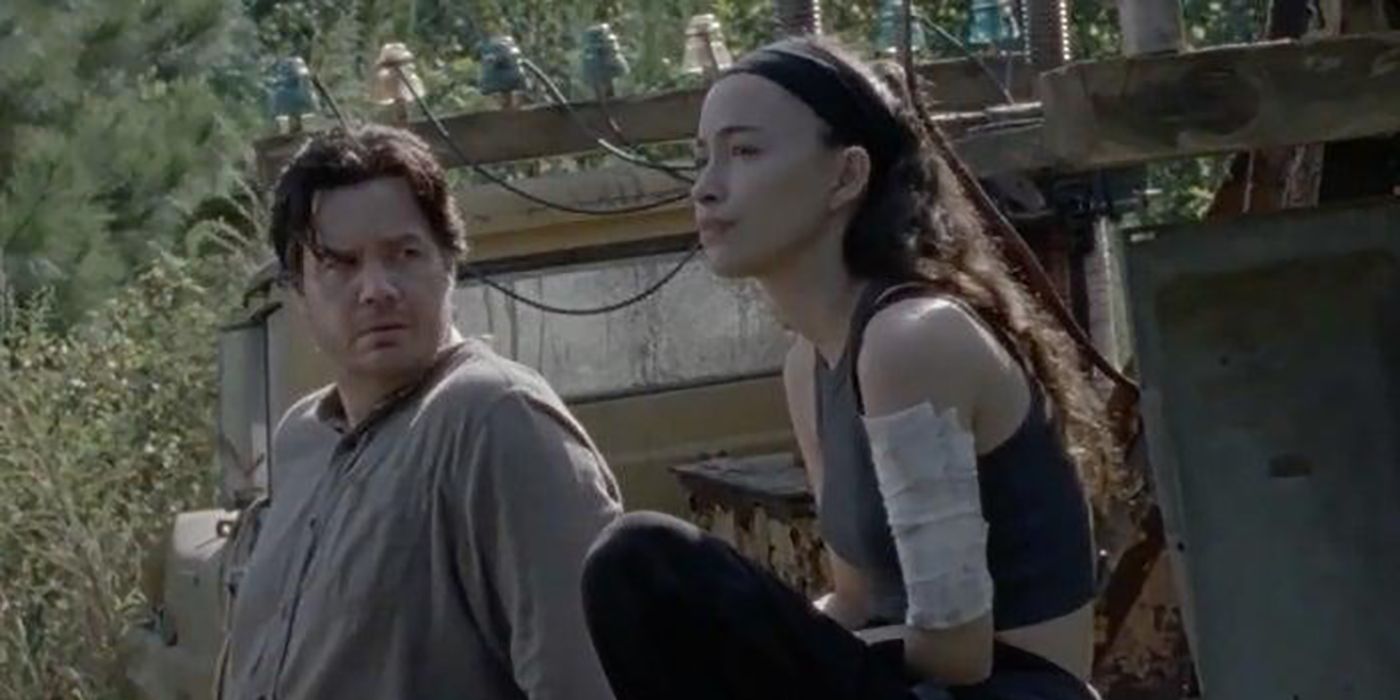 Eugene and Rosita from The Walking Dead sitting outside together talking.