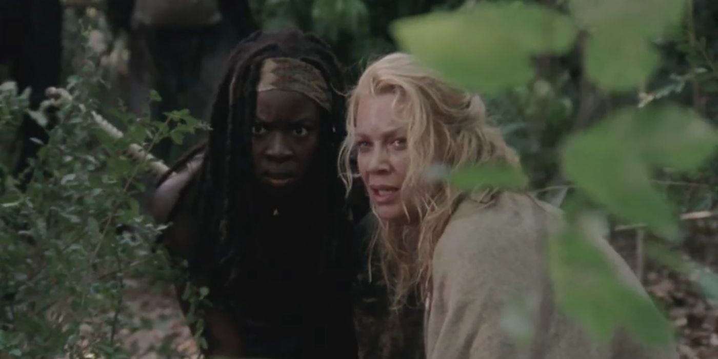 Andrea and Michonne from The Walking Dead hiding behind leaves.