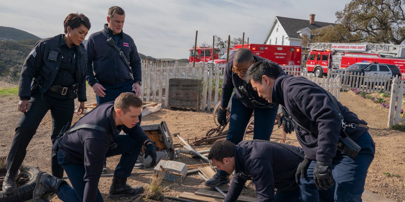 The 9-1-1 crew looking down into a sewage drain pipe