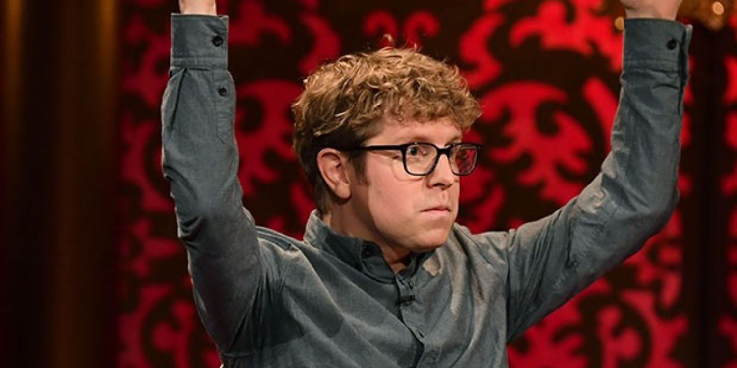 An image of Josh Widdicombe with his arms up
