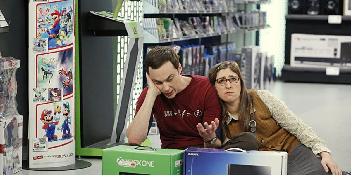 An image of Sheldon and Amy sitting on the floor in the game store in The Big Bang Theory