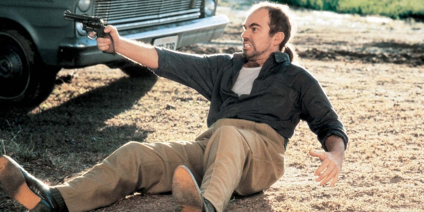 Ray Malcolm on the floor pointin a gun in One False Move.