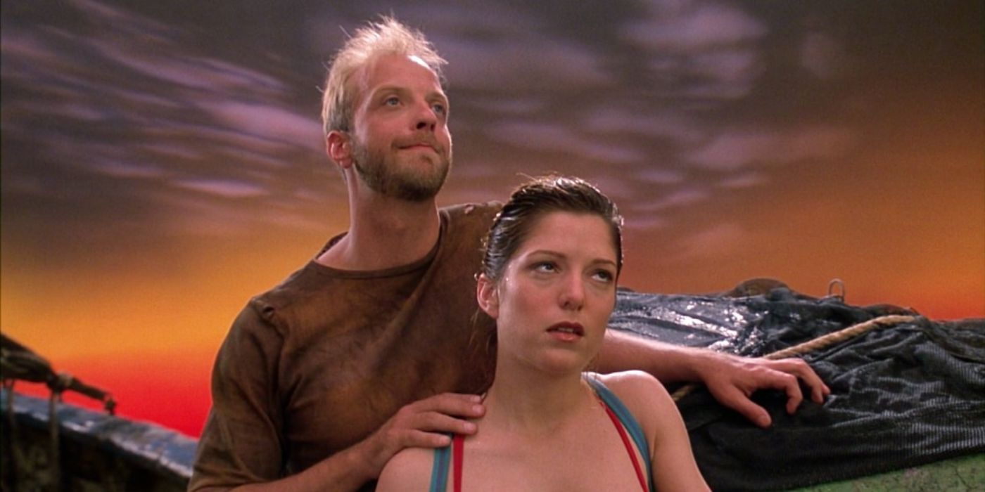 A man and woman dramatically looking off into the distance together, with his hand on her shoulder while she is rolling her eyes
