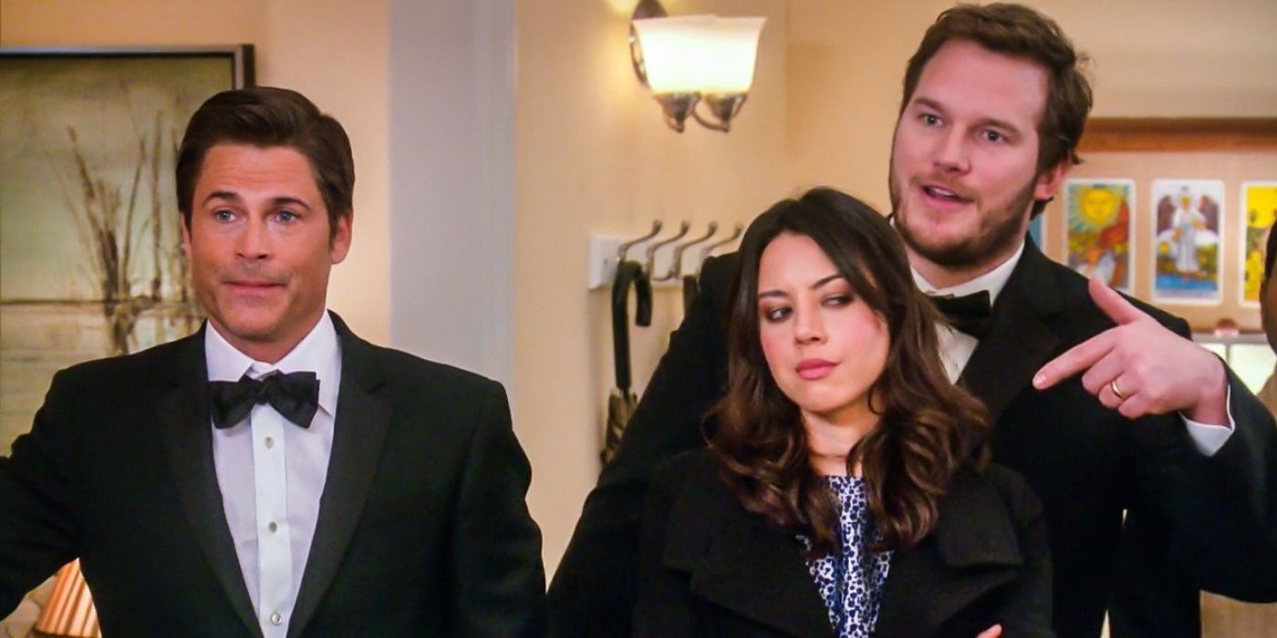Chris and Andy dressed in suits with April on Parks and Rec