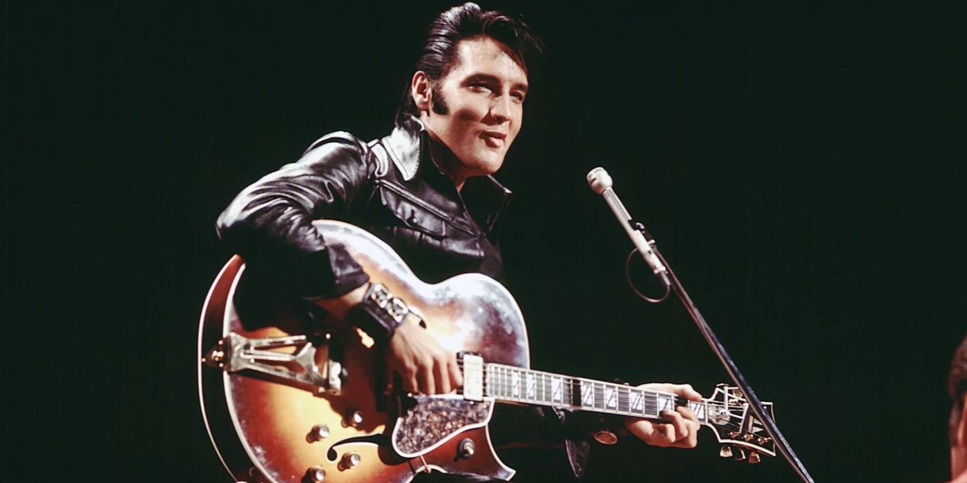 Elvis playing guitar on stage