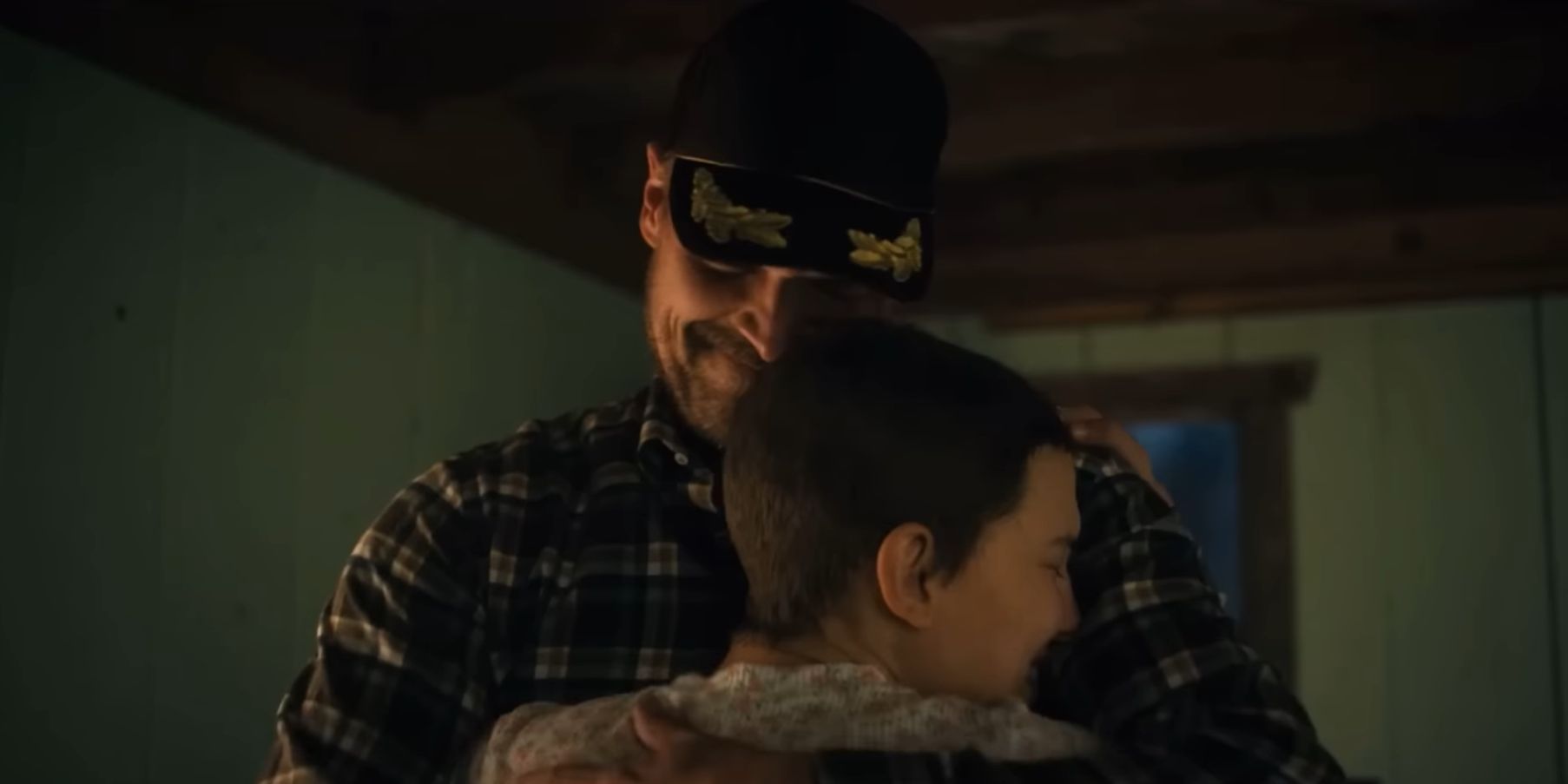 Hopper smiling and hugging a crying Eleven in her room