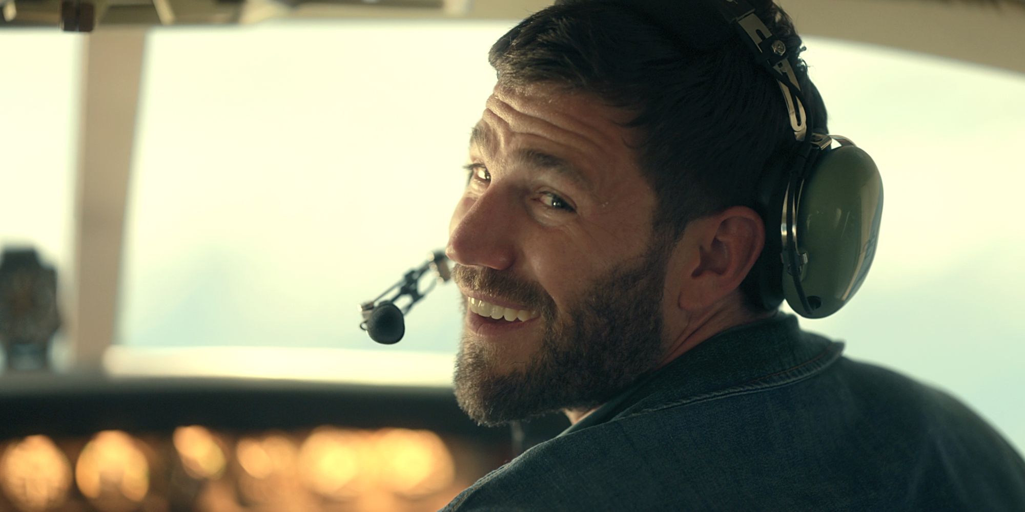 Austin Stowell como Sam en el avión con auriculares en el episodio de la temporada 1 Keep Breathing