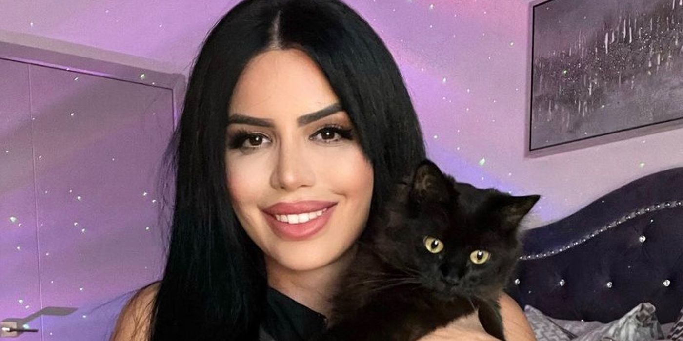 Larissa Lima 90 Day Fiancé smiling with pet black cat