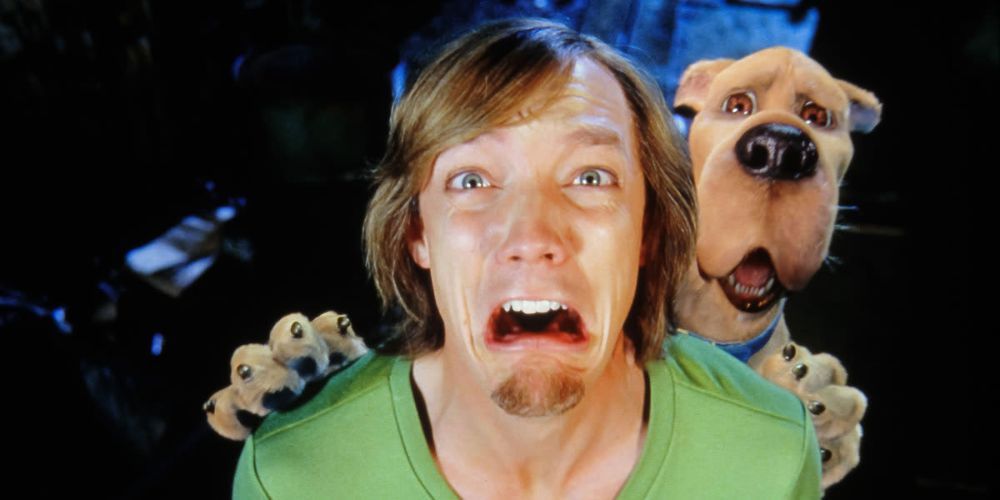 Matthew Lillard as Shaggy screams with Scooby by his side when he sees a monster