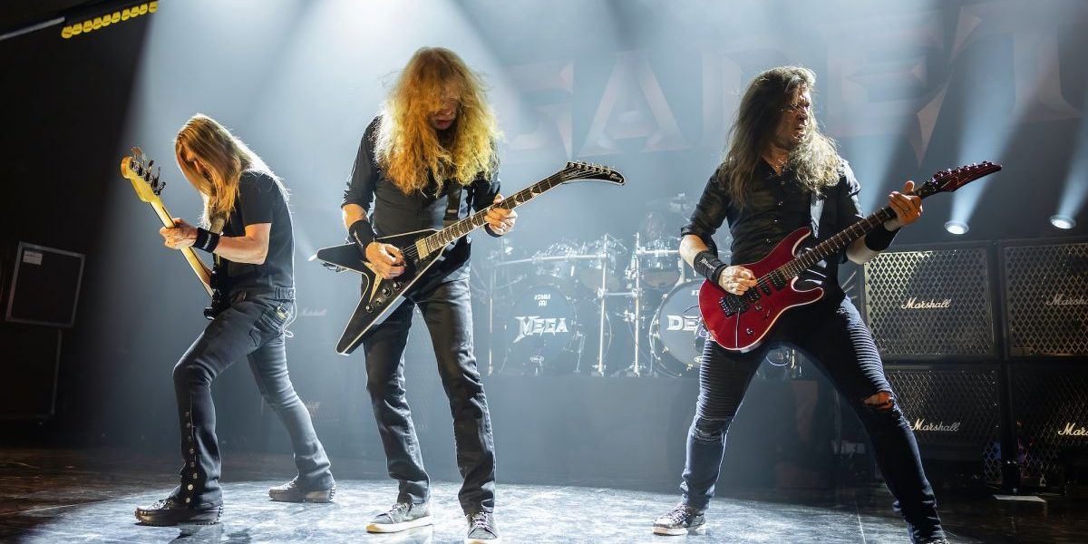 Image of Megadeth playing on stage at a concert