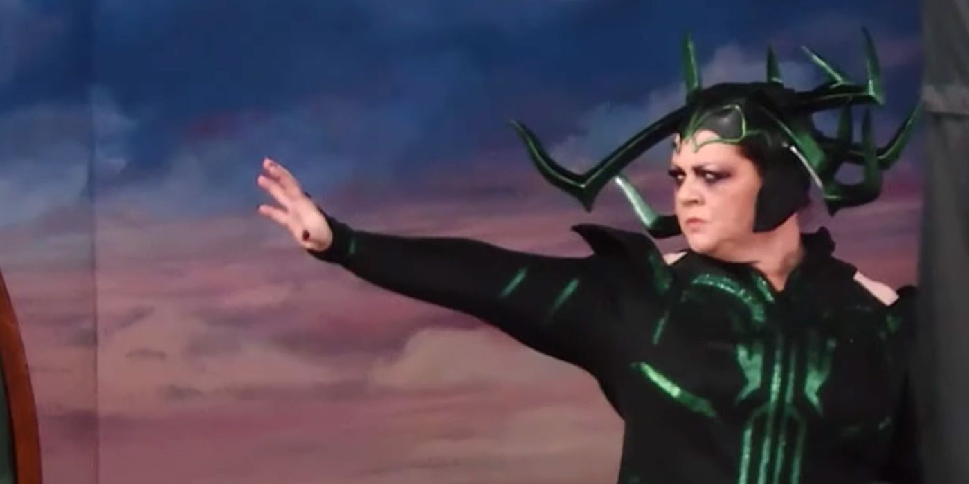 Melissa McCarthy raising a hand as Hela in Thor Love and Thunder Cropped