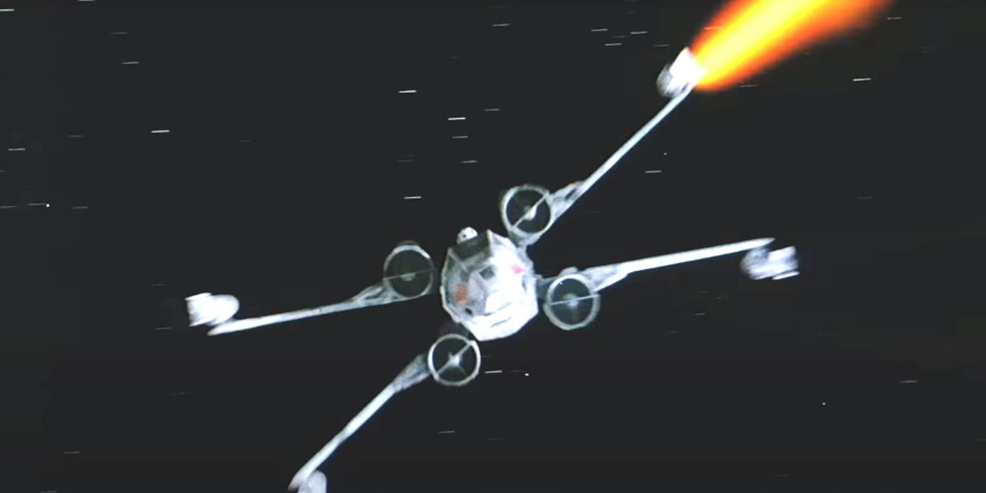 X-Wing fighter flies toward camera firing laser blast