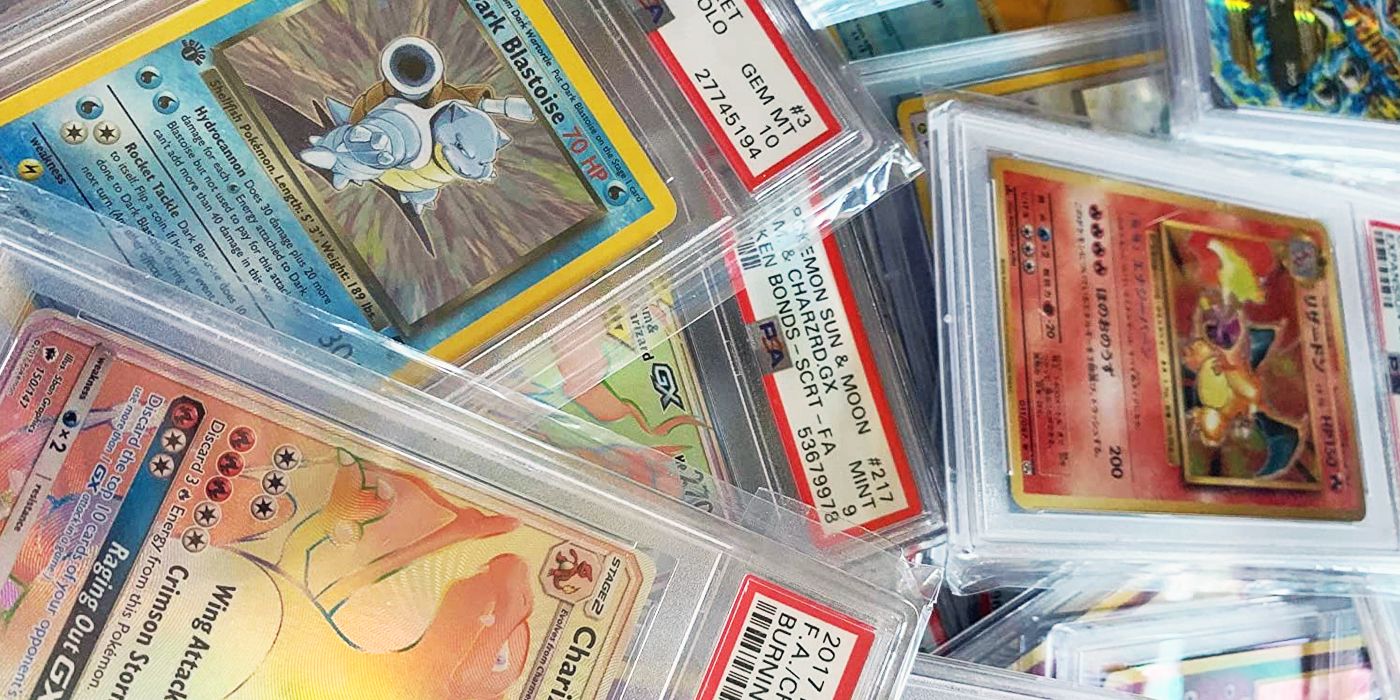 A pile of graded Pokemon cards strewn haphazardly.