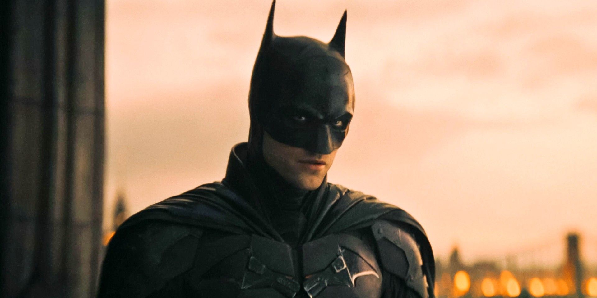 Robert Pattinson in The Batman with Gotham behind him