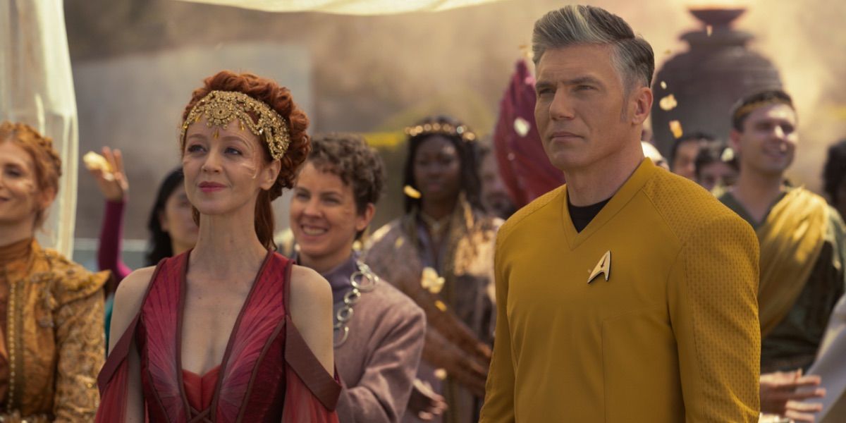 Captain Pike stands next to woman in royal garb from Strange New Worlds 