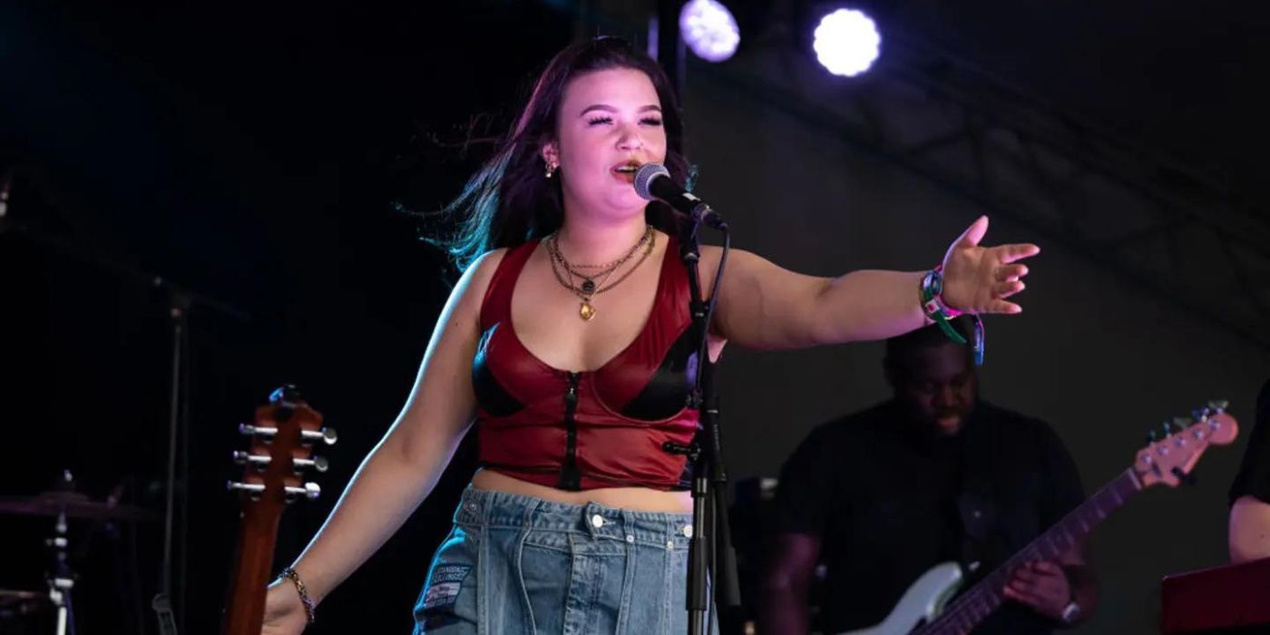 British singer Lola Young performing on stage.