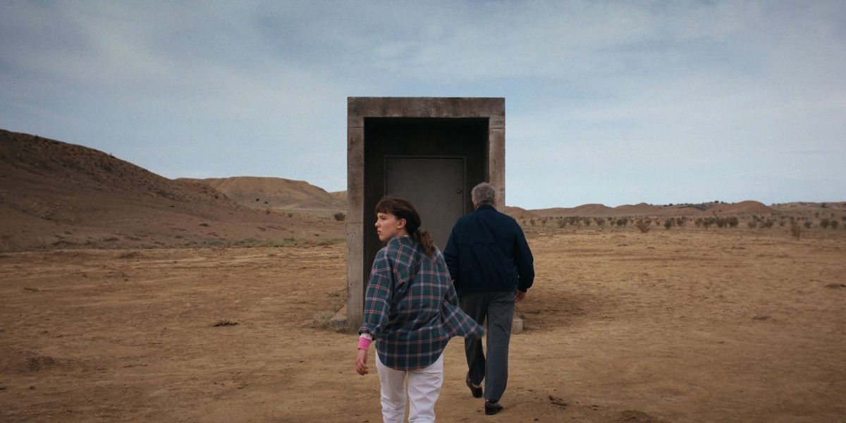 El and Dr. Owens walking to the random door in the middle of the desert