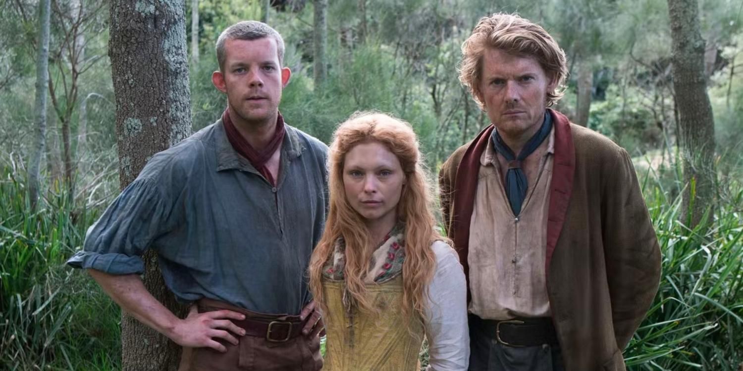 Three characters from Banished stand together in the woods