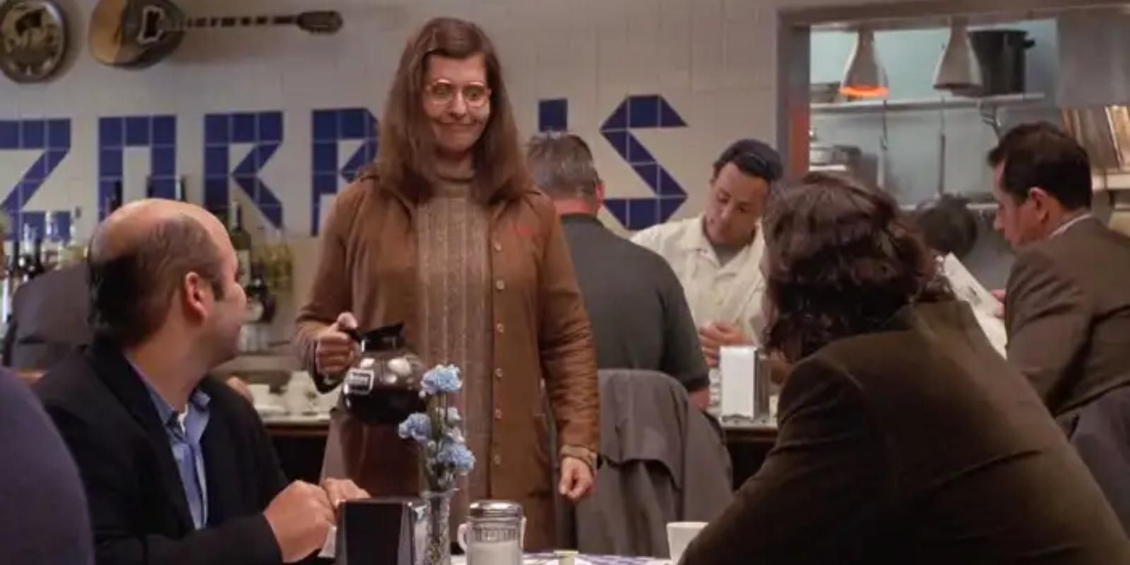 Toula Portokalos stands awkwardly beside the table of Ian Miller in My Big Fat Greek Wedding