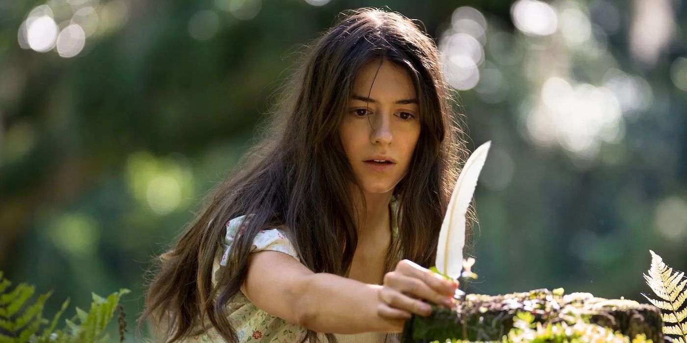 A dark-haired girl holds a white feather